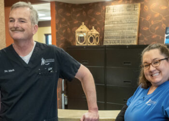 Doctor and nurse smiling at dental office at Jackson, MI